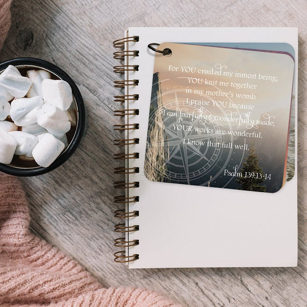 Scripture card with Psalm 139:13-14 printed over a scene of mountains and a sunset.