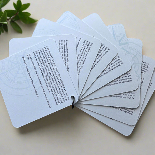 The backside of the scripture cards fanned out showing the devotions on the back of each card.