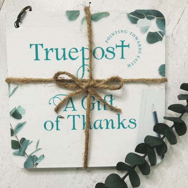 A gift of thanks scripture devotional cards beautifully wrapped with natural jute twine and tied in a bow, for a charming rustic vibe.