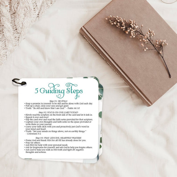 5 guiding steps for spending time with God card. Sitting on a blanket next to a book a flower.