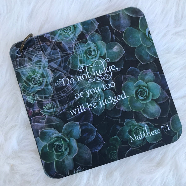 Scripture card of Matthew 7:1 printed over a color photo of  succulents.