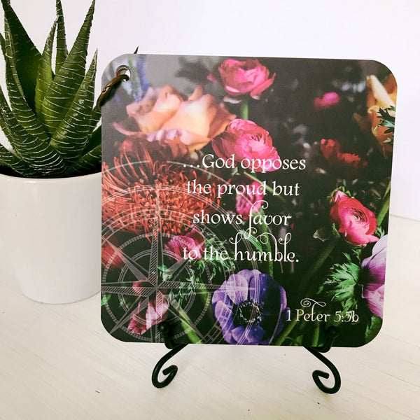 Scripture card with 1 Peter 5:5b displayed on the black iron display easel.