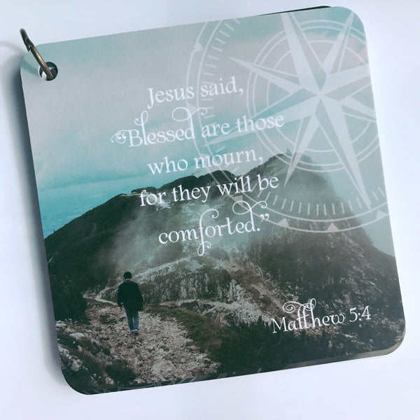 Scripture card on mourning and loss from Matthew 5:4 printed over a photo of a man walking up a mountain.