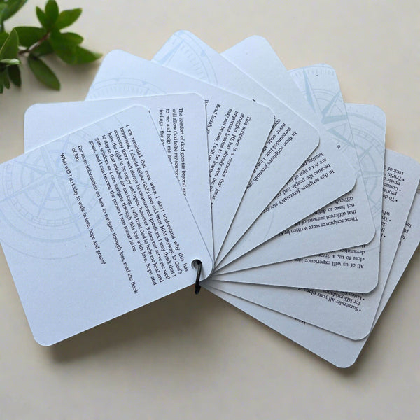  The backside of the scripture cards fanned out showing the devotions on the back of each card.