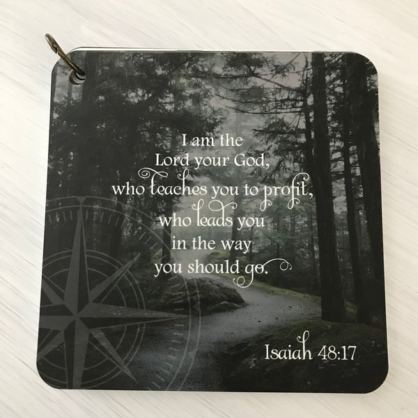 A scripture card with the scripture Isaiah 48:17 printed over a black and white wooded scene.