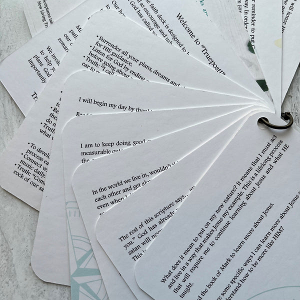 The backside of the scripture cards fanned out showing the devotions on the back of each card.