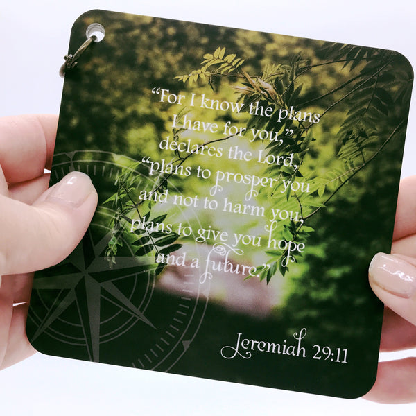 Scripture card with Jeremiah 29:11 printed over a full color photo of green trees in the background. Daily scripture card.