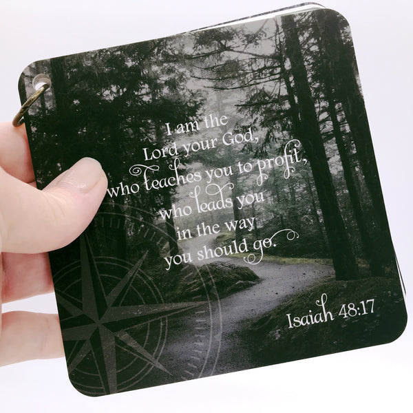 Scripture card with Isaiah 48:17 printed over a photo of a path through the woods. Scripture of the day card.