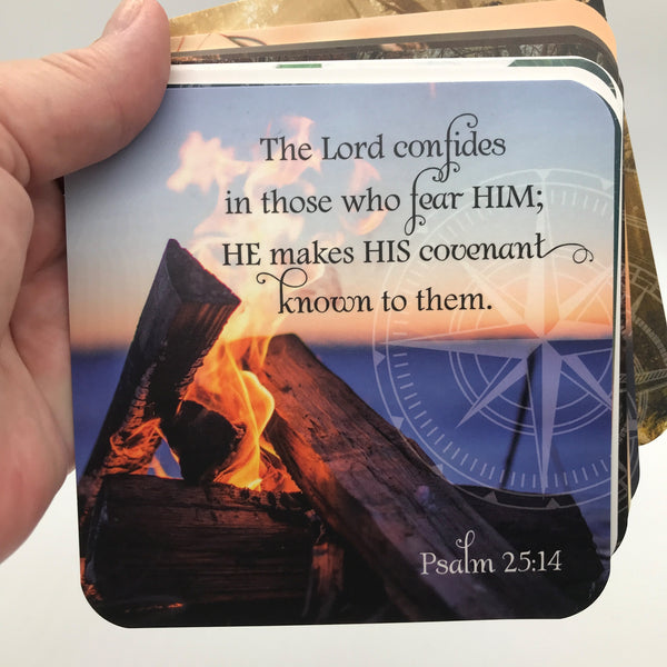 A gift of thanks scripture card featuring Psalm 25:14 the Lord confides in those who fear him printed over a photo of a campfire with water in the background.