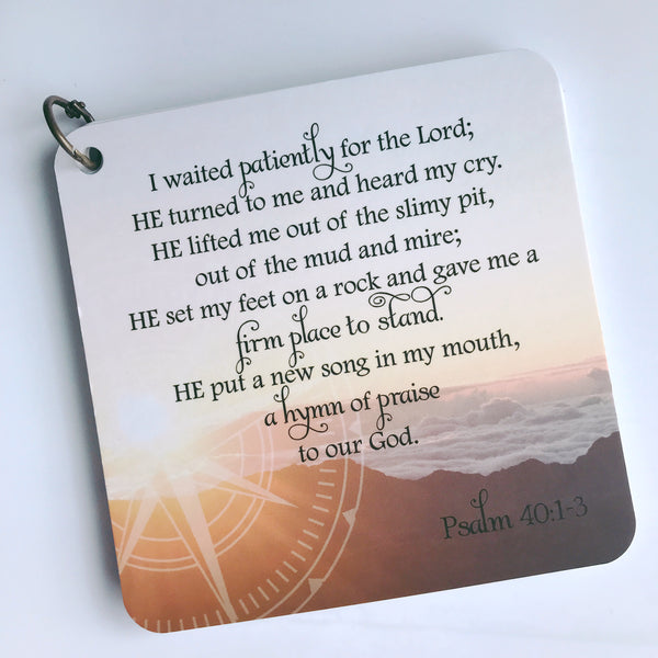 Scripture card on anxiety and worry from Psalm 40:1-3 printed over a photo of an ocean and mountains. Daily Christian message card.