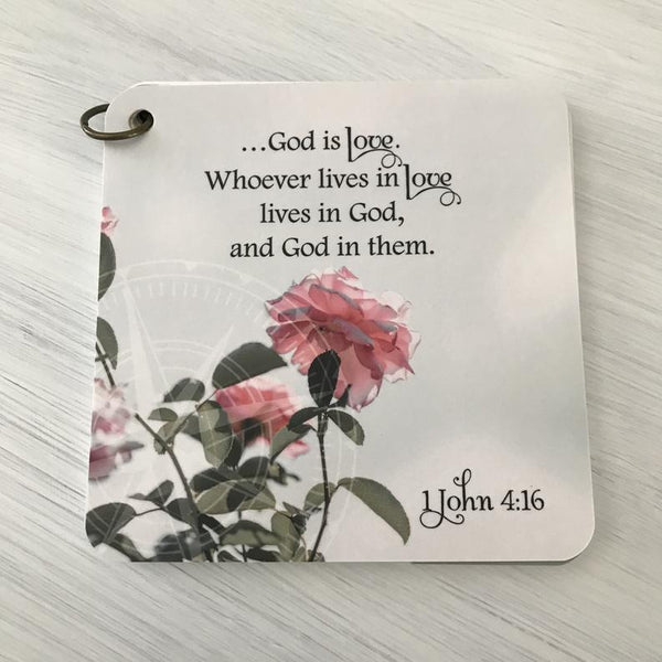 Scripture card of 1 John 4:16 God is love printed over a photo of pink roses.  Daily scripture card.