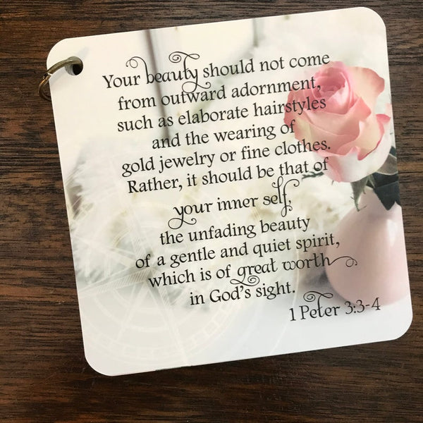 Scripture card of 1 Peter 3:3-4, printed over a photo of a pink rose in a light pink vase. Daily scripture card.