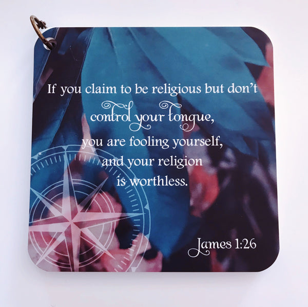 Scripture card of James 1:26 printed over a full color photo of green leaves and  a pink flower in the background.