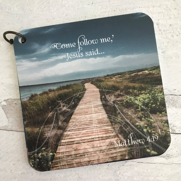 Scripture card of Matthew 4:19 printed over a photo of a wooden walkway out towards the ocean.