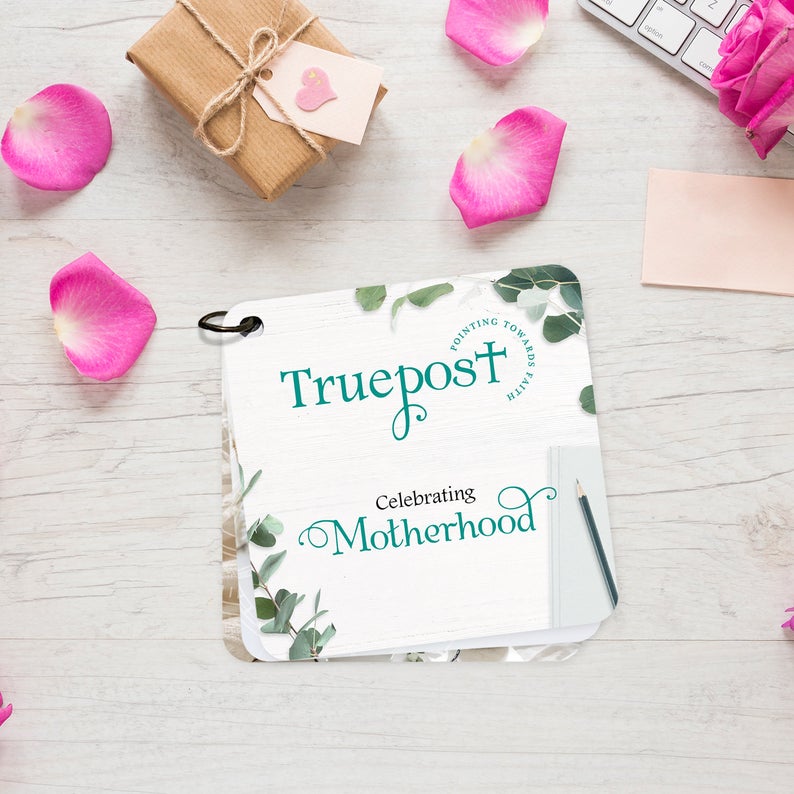 This is the cover of the Truepost scripture card set titled Celebrating Motherhood, with eucalyptus leaves cascading about the card. . Christian message cards for women. Inspirational gift for moms