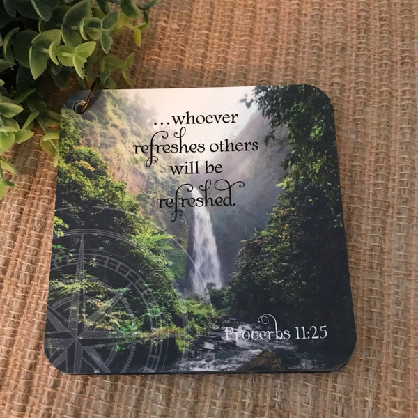 Scripture card of Proverbs 11:25 whoever refreshes others will be refreshed printed over a phot of a waterfall with a back drop of lush greenery.