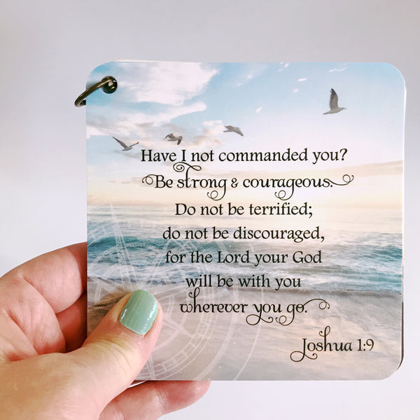 Scripture card on anxiety and worry from Joshua 1:9 printed over a photo of an ocean & clouds. Daily Bible verse on overcoming anxiety.