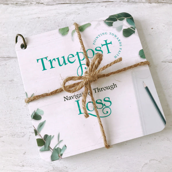 Navigating Through Loss scripture devotional cards beautifully wrapped with natural jute twine, tied in a bow, for a charming rustic vibe. The cards are pictured on a white background.