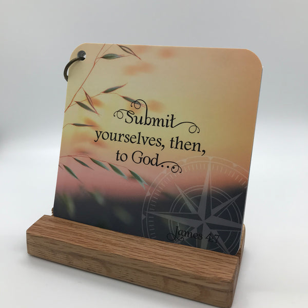 A gift of thanks scripture card featuring James 4:7 submit yourselves, then to God printed over a photo of green leaves and an autumn-colored sky.
